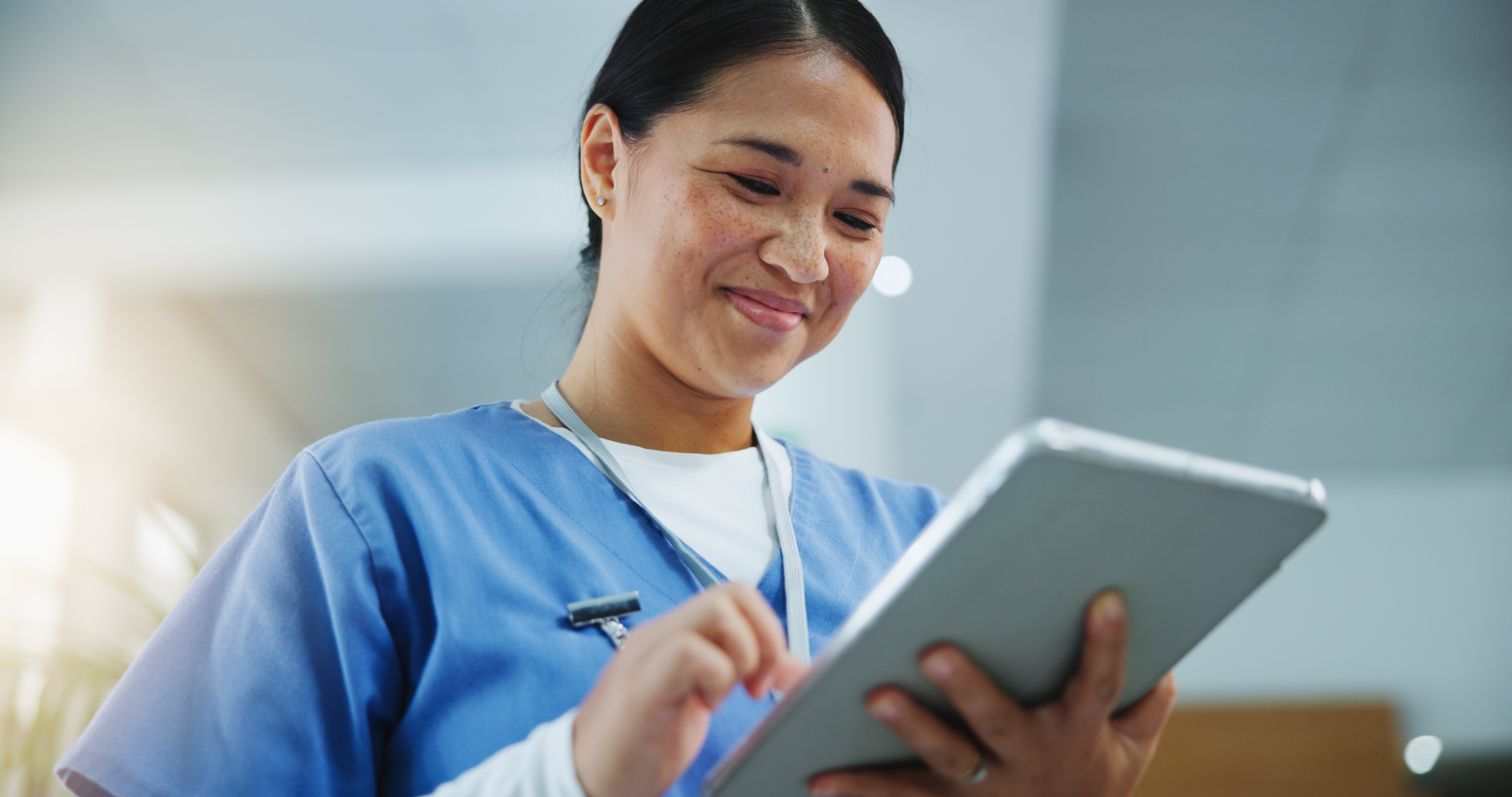 Clinical Medical Assistant working on a tablet