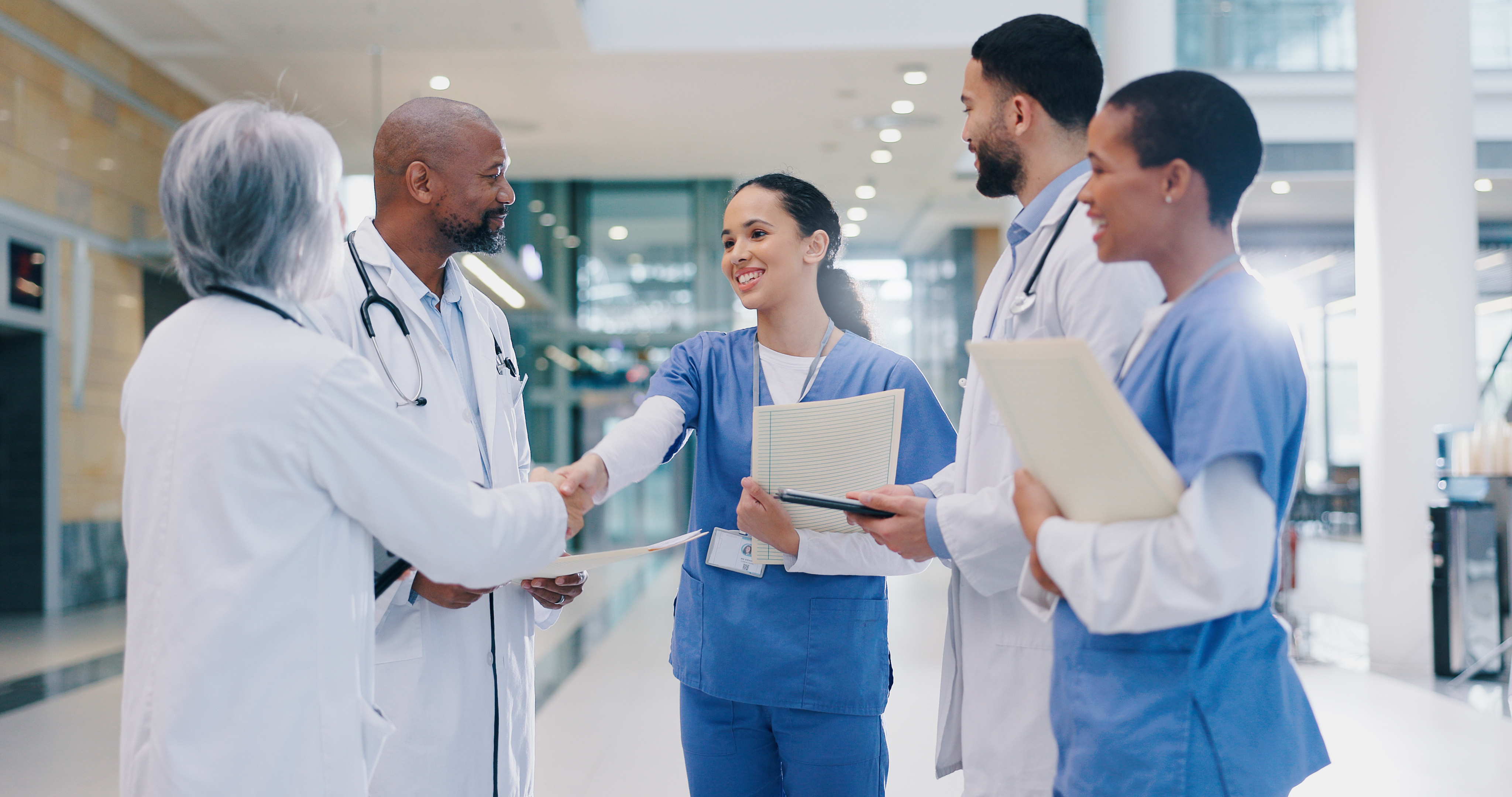 Medical team meeting in a hallway